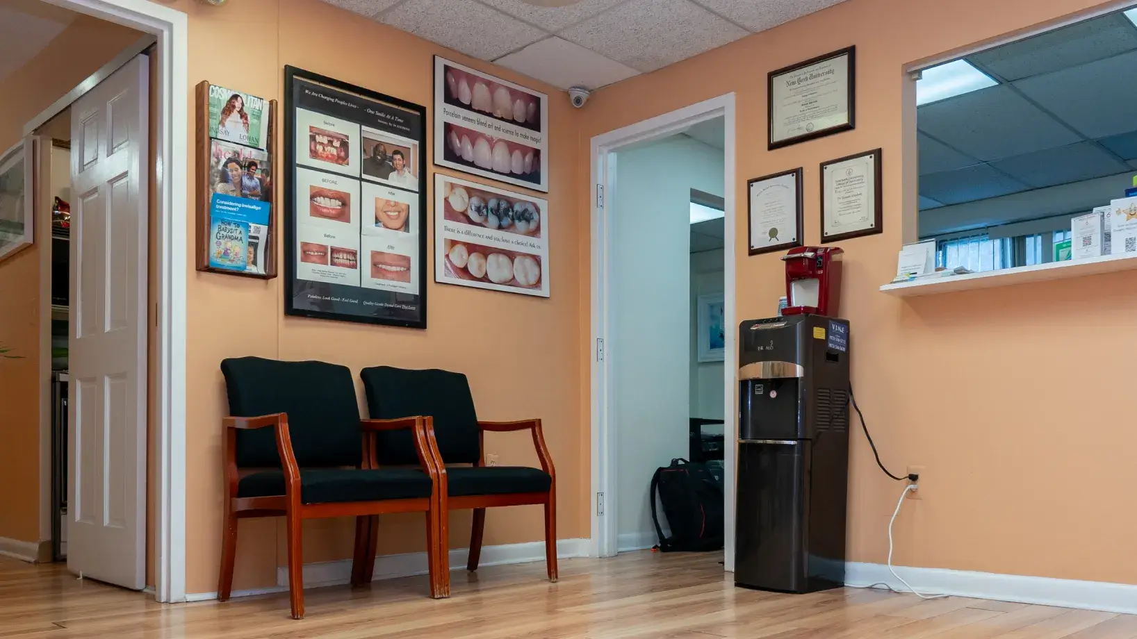 a waiting room with two chairs and pictures on the wall