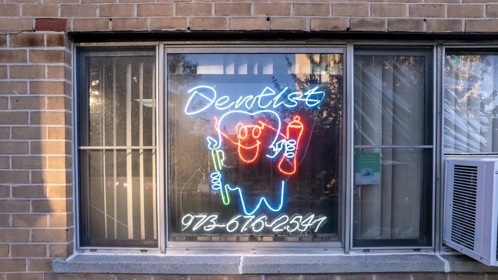 a neon sign on the window of a building